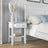 Bedside table N01 wooden white in bedroom – arrangement with bedside lamp